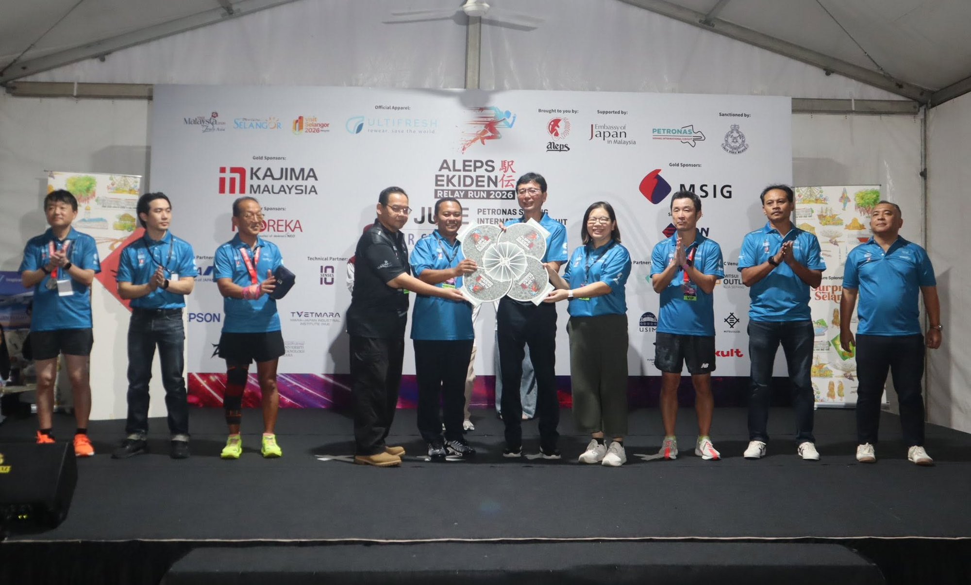 NEOREKA ASIA representatives on stage at the ALEPS Ekiden 2026 sponsor ceremony