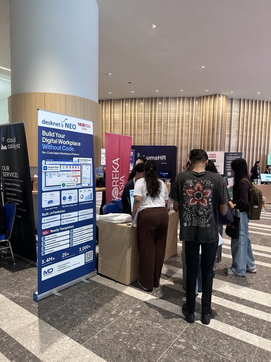Visitors at the NEOREKA ASIA booth beside the desknet's NEO no-code digital workplace banner at IA Business Summit 2026
